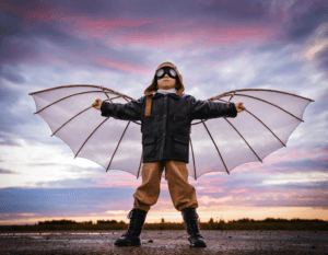 Boy dressed as pilot with wings