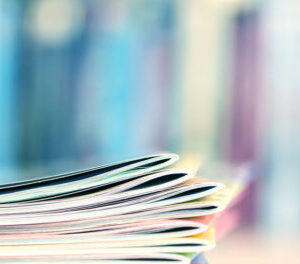 Customer publications - Close up edge of colorful magazine stack