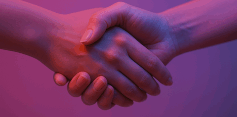 Hands shaking in a fushcia and magenta background.
